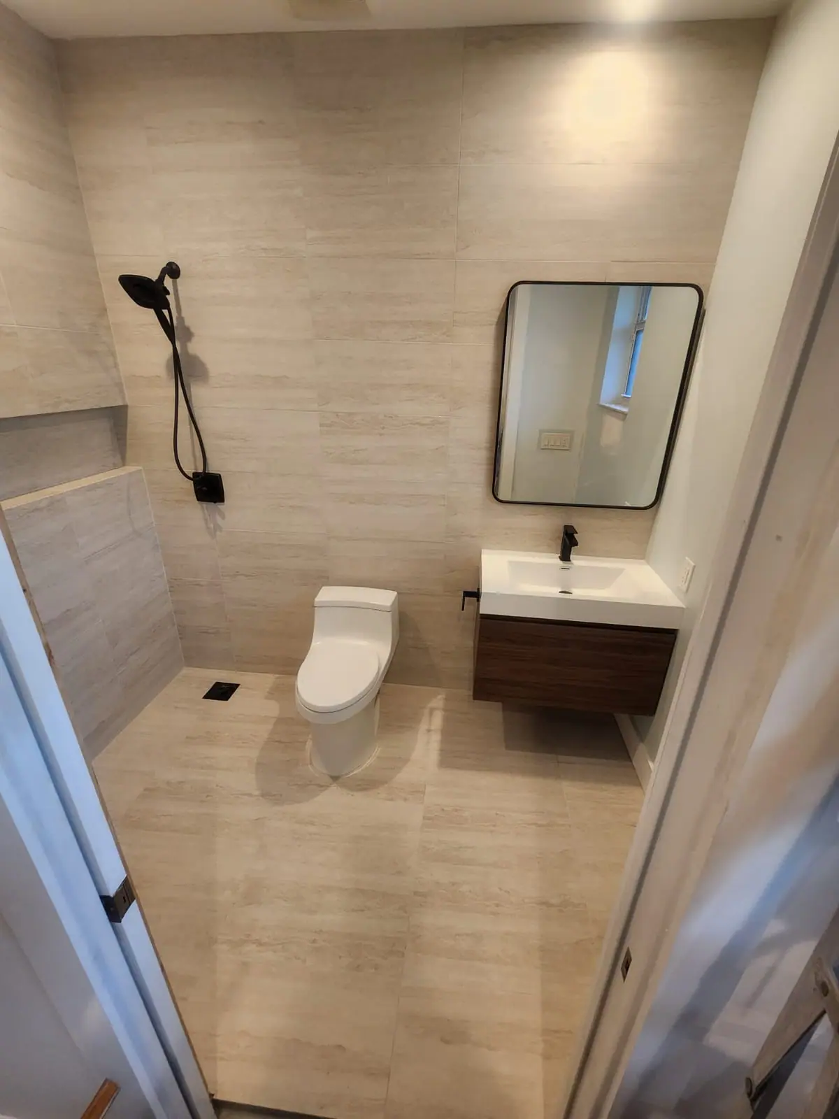 Warm neutral bathroom with black fixtures